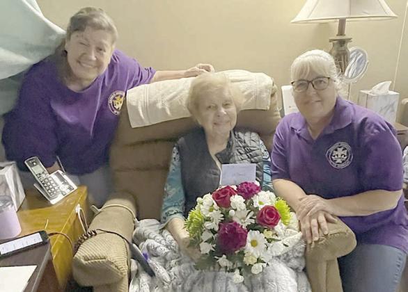 Lois Demel (center) was presented a bouquet of flowers for her 100th birthday by Catholic Daughters Court St. Rose 1597, represented by Grace Lebeda (left), regent, and Phyllis Valchar (right), recording secretary.