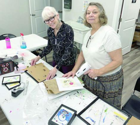 Thanks to Kim Penland (left) and Claire Lewis (right), 99 percent of the framing was completed for the art show “Ageless Artistry,” on Saturday, April 12 from 3 to 5 p.m. at 1206 Kessler Ave. in Schulenburg.