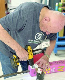 Helping put Senior Connections plaques on garden poles that are soon to be distributed to supporters is Lee Ehler – watch for them in the community.