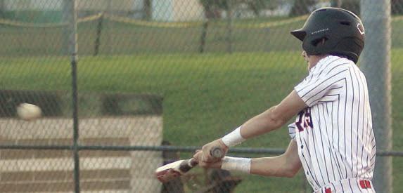 Zane Brenek sends an RBI-single up the middle against Louise. Sticker Photo By Darrell Vyvjala