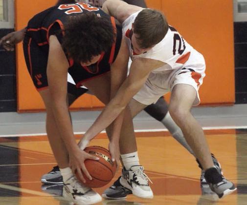 Zane Brenek ties up a Tiger in the second half last Tuesday. Sticker Photo By Darrell Vyvjala