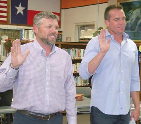 Joel Blansitt (left) and Shannon Hollas take the oath of office, administered by Schulenburg ISD Business Manager Lynne Machac during Monday night’s Board of Trustees meeting. Sticker Photo By Darrell Vyvjala