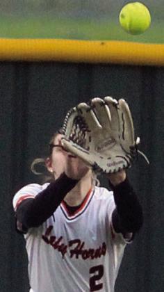 Fay Kutac tracks down a fly ball in centerfield. Sticker Photo By Darrell Vyvjala