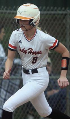 Olivia Mathis heads home with a run in the first inning. Sticker Photo By Darrell Vyvjala