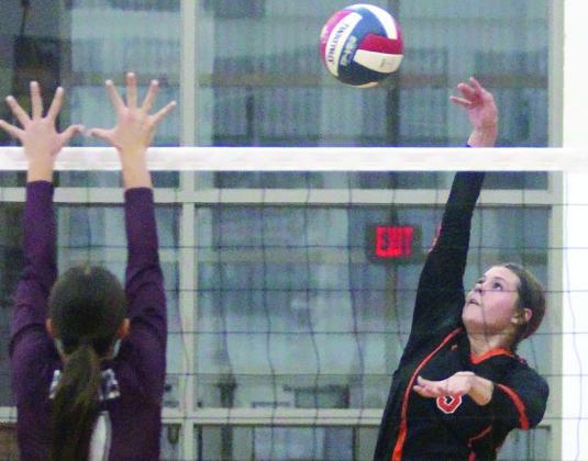 Haylee Vacek slips a kill cross-court to tie the fourth set last Tuesday’s at 23-23. She later put down the deciding point in the Lady Horns’ 29-27 win. Sticker Photo By Darrell Vyvjala