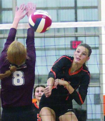 Emmrie Marx fires a kill past a Brahmarette block attempt early in game four. Sticker Photo By Darrell Vyvjala