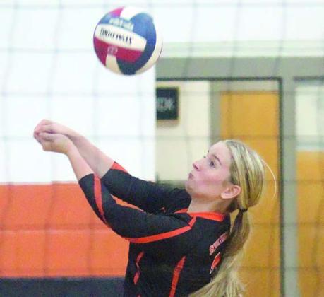 Madison Kunschick tracks down an East Bernard spike in the third set. Sticker Photo By Darrell Vyvjala