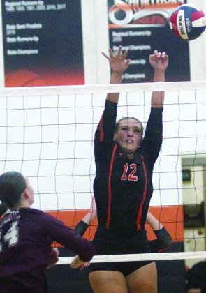Grace Schramek rejects a Brahmarette attack in game three of the season opener. Sticker Photo By Darrell Vyvjala