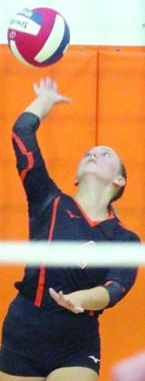 Avery Helms serves an ace late in the fourth set against East Bernard. Sticker Photo By Darrell Vyvjala