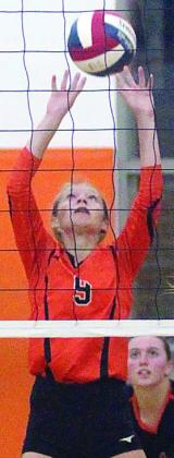 Michaela Kollmann reaches up to get to a Brahmarette attack in game four. Sticker Photo By Darrell Vyvjala