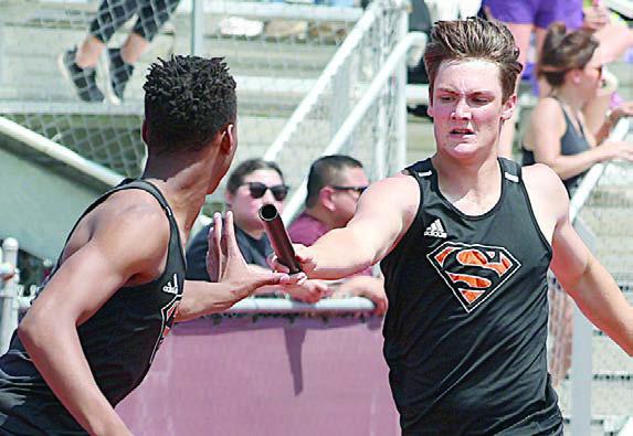 Owen Brenek hands off to Jakelle Houston in the 1600-meter relay, in which the Horns placed fourth. Photo By Melanie Berger / Courtesy of Flatonia Argus