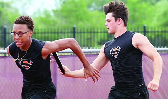 Preston Kahn hands off to Ja’Kaden Houston in the 400-meter relay. Photo By Melanie Berger / Courtesy of Flatonia Argus