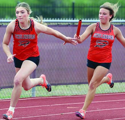 Greenli VanZandt takes the baton from Ellie Hammack in the 400-meter relay. Photo By Melanie Berger / Courtesy of Flatonia Argus