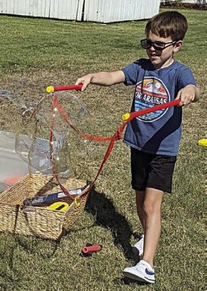 Creating giant bubbles was one of the outdoor activities available in the open field located near the Stanzel Model Aircraft Museum.