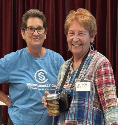 SENIOR SPOTLIGHT – Stephanie Shroyer (left), Senior Connections program director, presents Rita Hays (right) with cookies from the cookie roundup for her bravery in sharing her story during Senior Spotlight in Weimar. Her story was very compelling about how painting and her love of horses brought her through some very difficult times.