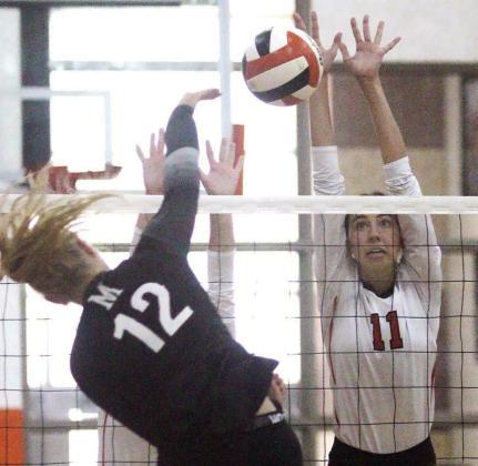 Meredith Magliolo goes up to block a Crusader attack in game two. Sticker Photo By Darrell Vyvjala