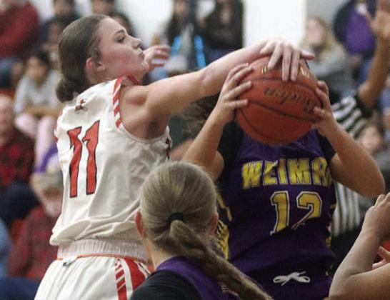 Alana Herzik fights for a rebound in the second half on Dec. 20. Sticker Photo By Darrell Vyvjala