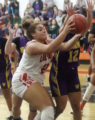 Arianna Vincent grabs an offensive rebound before getting fouled by a Ladycat on a put-back shot in the fourth quarter. Sticker Photo By Darrell Vyvjala