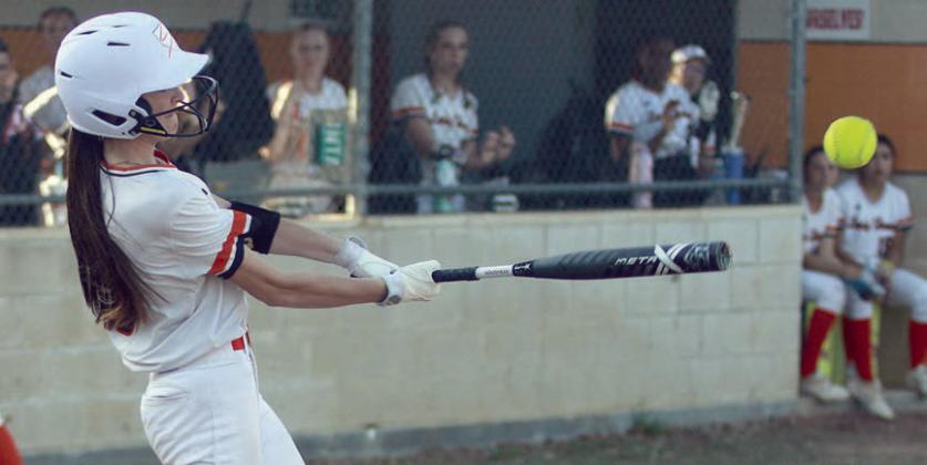 Ava Faith sends a single to left field in the Lady Horns’ win on Friday. Sticker Photo By Darrell Vyvjala