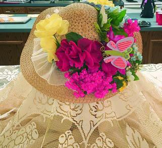 TWO OF THE Decor ations at the Garden Club meeting were a lovely centerpiece (photo above and also shown behind the hostesses) and a rabbit that reflected the Easter theme (photo at right).