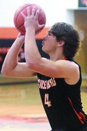 Jayse Janda sets for a three-pointer in the first quarter against Columbus. Sticker Photo By Darrell Vyvjala