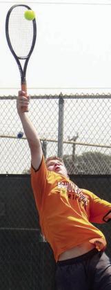 Caden Herzik makes a leaping volley at the net. Sticker Photos By Darrell Vyvjala