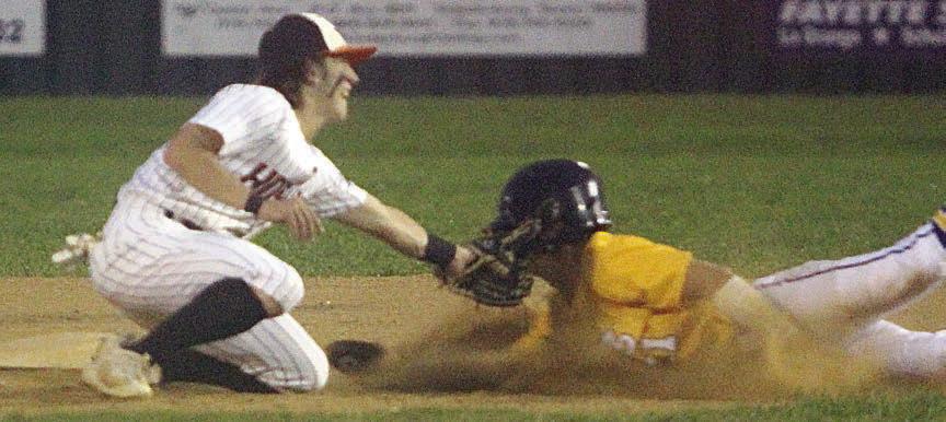 Second baseman Cooper Demel tags out Shiner’s Carson Schuette on a steal attempt. Sticker Photo By Darrell Vyvjala