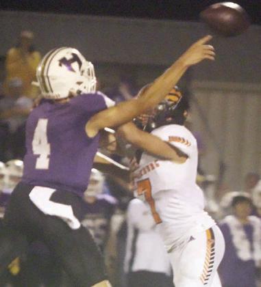 Bryce Stoever pressures Desi Cantu into an incomplete pass in the fourth quarter. Sticker Photo By Darrell Vyvjala