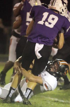 Adin Beyer brings down Ryan Steglich for a loss of 3 in the first quarter. Sticker Photo By Darrell Vyvjala
