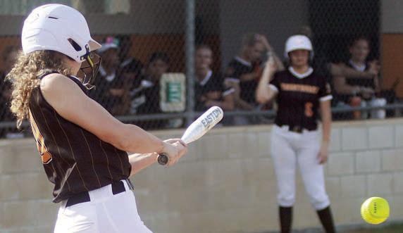 Grace Schramek sends a single up the middle early in the first game of last week’s doubleheader. Sticker Photo By Darrell Vyvjala