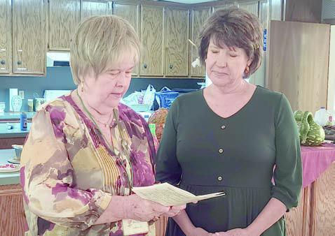 New member Diane Holub (right) was given the oath of membership by president Bonnie Baker (left).