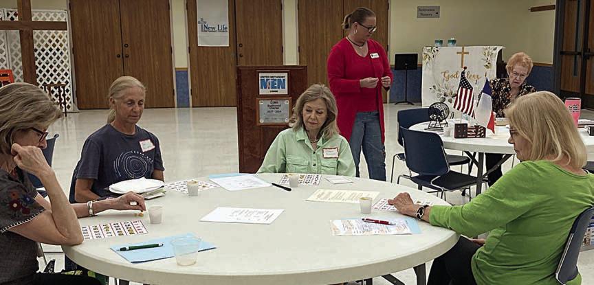 Retired teach ers “studying” bingo cards at the conclusion of the May meeting.
