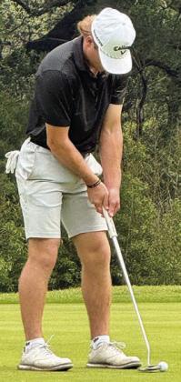 Reid Janda strokes a putt in the first round of the state tournament.