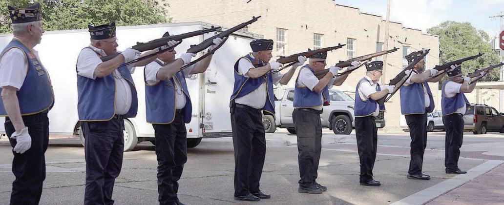 Members of the Schulenburg American Legion McBride Post 143 deliver the triple volley salute as part of the patriotic ceremony. Participating were: (from left) Harry Bartosch, Dennis Muhlstein, Jack Niesner, James Brown, C. W. Leonard, Michael Bartos, Rick Todd, and Armen Herzik.