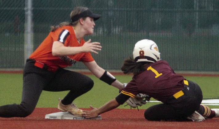 Shortstop Haylie Goode tags out a Trojanette on a steal attempt in game one. Sticker Photo By Darrell Vyvjala