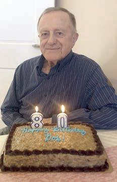 Celebrating his 80th birthday was Bob Heinsohn, shown with his birthday cake.