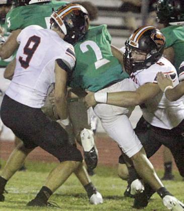 Adin Beyer (No. 9) and Owen Brenek combine for a tackle behind the line of scrimmage in the second quarter. Sticker Photo By Darrell Vyvjala