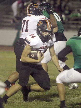 Mason Kunschick uses the block of Calvin Thompson (No. 71) to gain 7 yards in the second quarter. Sticker Photo By Darrell Vyvjala