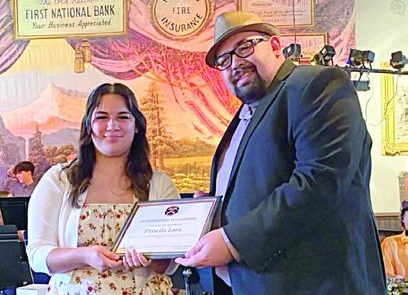 Outstanding Woodwind Aw ard was presented to Priscila Lara (left) by SISD band director Justin Bartlett (right).