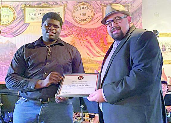Most improved award was presented to Rogerick H Walton (left) by SISD band director Justin Bartlett (right).