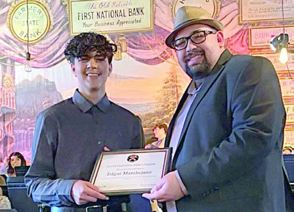Outstanding PercussionAw ard was presented to Edgar Mandujano (left) by SISD band director Justin Bartlett (right).