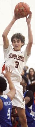 Adam Schramek dishes to a teammate under the basket for a first-quarter score against Waelder. Sticker Photo By Darrell Vyvjala