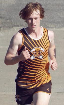 Cody Lewis heads across a bridge on his way to a ninth-place finish. Sticker Photo By Darrell Vyvjala