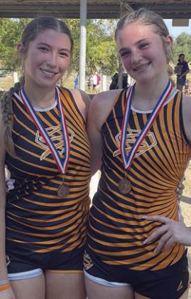 Earning medals in the junior varsity division were Gracie Burton (left), sixth place, and Alana Herzik, seventh. Sticker Photo By Darrell Vyvjala