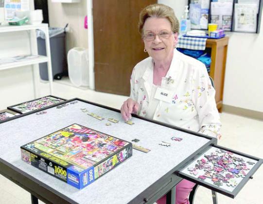 Happy to have a puzzle table at which to work at the Schulenburg Senior Connections site is Alice Fajkus.