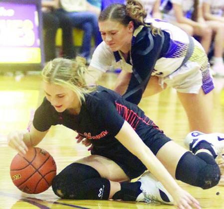 Alana Herzik goes to the floor to corral a loose ball in the third quarter. Sticker Photo By Darrell Vyvjala