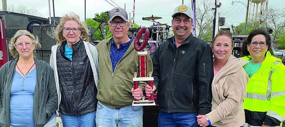 SMOKE SAUSAGE - 1ST PLACE: “TEAM EDDIE” – (from left) Debbie Moy, Celine Matthews, Tom Matthews, Corrie Bowen, Mary Beth Bowen, and Sherry Moy. Sticker Photo By Darrell Vyvjala