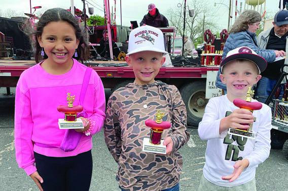 SAUSAGE TOSS (5- TO 8-YEAER OLDS): (from left) Kamila Grifaldo, third place; Andrew Holmes, second place; and Bryson Dees, first place. Sticker Photo By Darrell Vyvjala