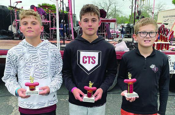 SAUSAGE TOSS (9- TO 12-YEAR OLDS): (from left) Jack Schiffli, third place; Cal Schiffli, second place; and Ty Hoffmann, first place. Sticker Photo By Darrell Vyvjala