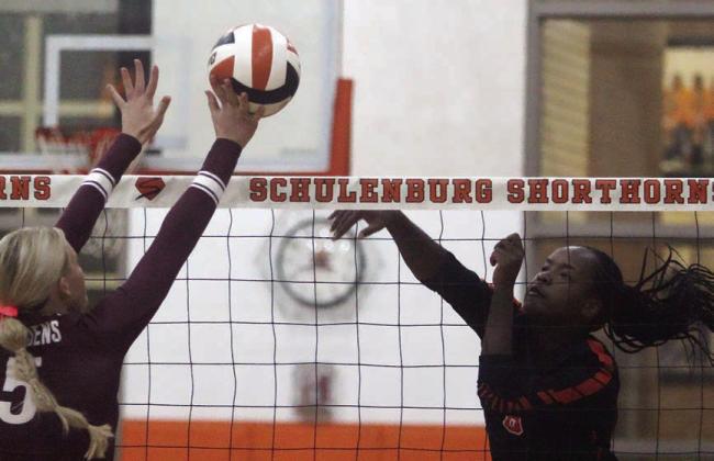 Jessalyn Gipson bangs a kill off a Maiden block attempt in the first set, one of her 15 last Tuesday. Sticker Photo By Darrell Vyvjala